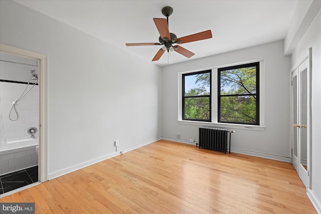 4007 Connecticut Ave NW Unit 302, Washington, DC 20008 - unfurnished bedroom featuring ensuite bath, baseboards, radiator heating unit, and light wood-type flooring