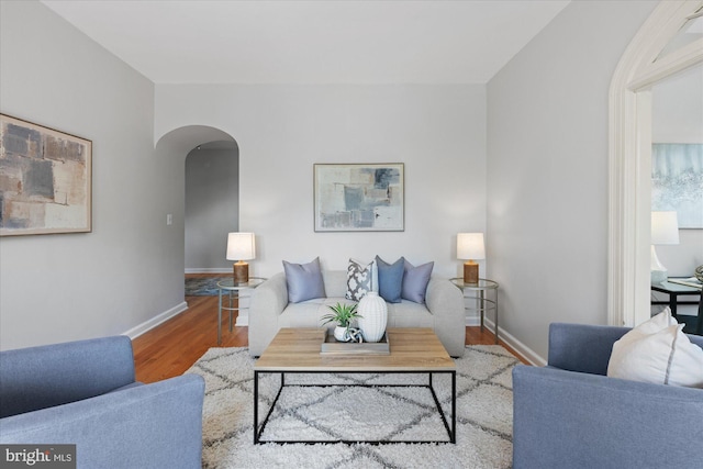 4007 Connecticut Ave NW Unit 302, Washington, DC 20008 - living area with arched walkways, wood finished floors, and baseboards
