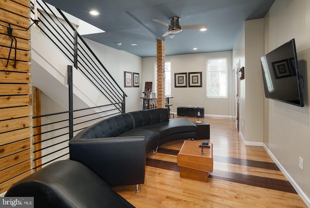 living room featuring ceiling fan, recessed lighting, baseboards, wood finished floors, and stairway