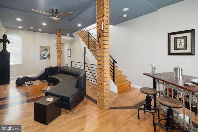 interior space featuring ceiling fan, wood finished floors, stairway, baseboards, and recessed lighting