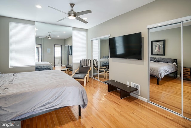 bedroom featuring a ceiling fan, visible vents, wood finished floors, baseboards, and recessed lighting