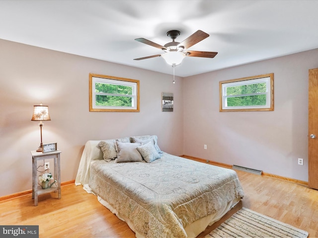11416 Kline Dr NW, Cumberland, MD 21502 - bedroom featuring multiple windows, light wood-style floors, and baseboards