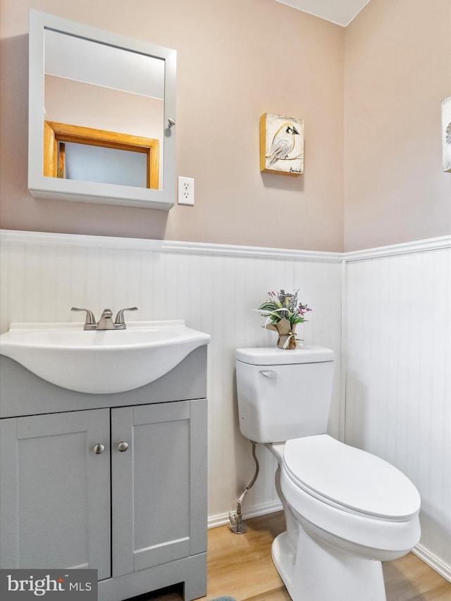 11416 Kline Dr NW, Cumberland, MD 21502 - bathroom featuring wood finished floors, a wainscoted wall, toilet, and vanity