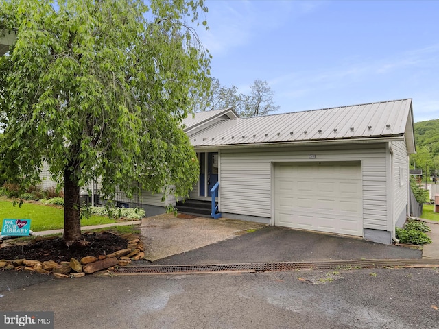 11416 Kline Dr NW, Cumberland, MD 21502 - view of front of home featuring a garage, metal roof, and asphalt driveway