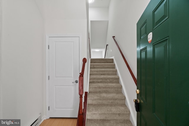 staircase with baseboards and wood finished floors
