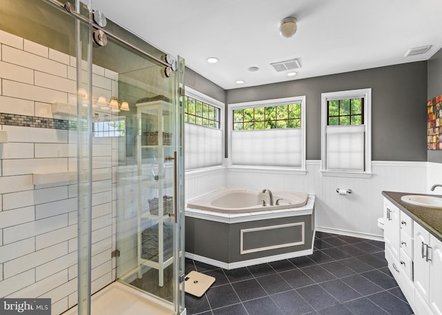137 E Holly, Haddon Township, NJ 08107 - bathroom with tile patterned floors, vanity, a garden tub, a stall shower, and a wainscoted wall