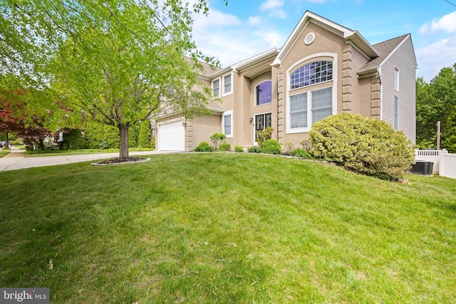 137 E Holly, Haddon Township, NJ 08107 - traditional-style home featuring a front yard, an attached garage, concrete driveway, stucco siding, and central AC
