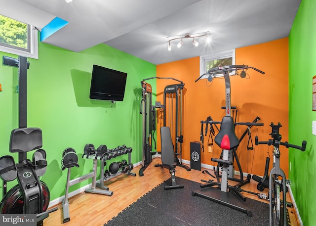 137 E Holly, Haddon Township, NJ 08107 - exercise area featuring wood finished floors, healthy amount of natural light, and baseboards
