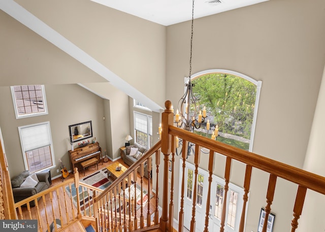 137 E Holly, Haddon Township, NJ 08107 - staircase with a chandelier, a towering ceiling, wood finished floors, and baseboards
