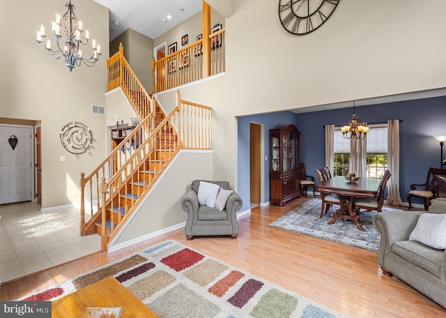 137 E Holly, Haddon Township, NJ 08107 - living room with a chandelier, stairway, a high ceiling, wood finished floors, and baseboards
