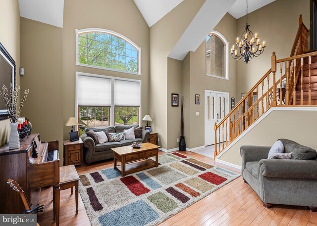 137 E Holly, Haddon Township, NJ 08107 - living area featuring a chandelier, high vaulted ceiling, stairs, light wood-style floors, and baseboards