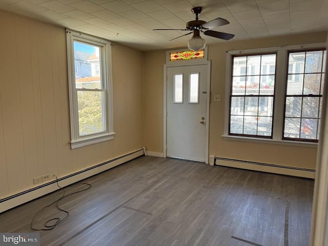 foyer with plenty of natural light, wood finished floors, and a baseboard radiator