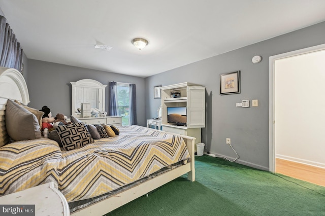 carpeted bedroom featuring baseboards