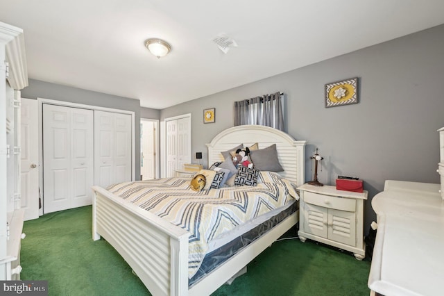 bedroom with carpet flooring and multiple closets