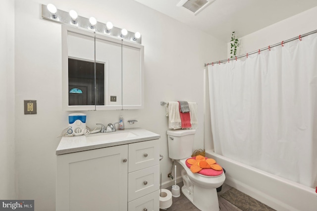 bathroom with vanity, toilet, and shower / bath combo