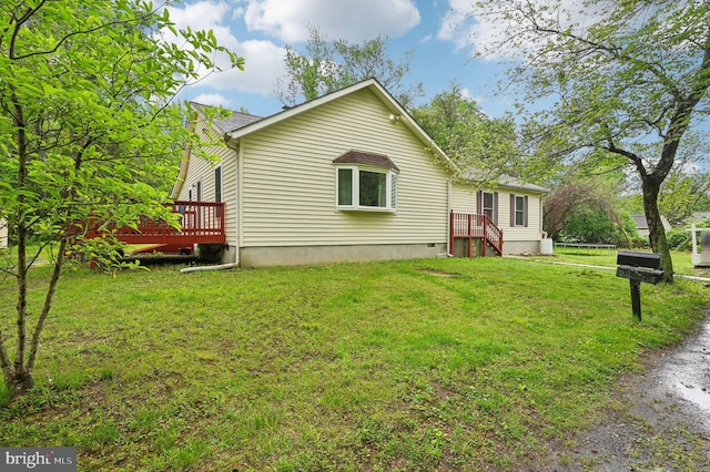 back of property featuring a deck, a yard, and crawl space