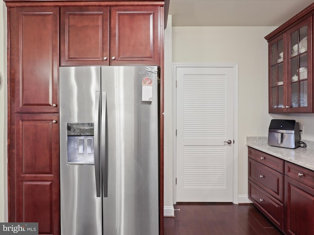 3911 Doc Berlin Dr Unit 35, Silver Spring, MD 20906 - kitchen with light stone counters, glass insert cabinets, baseboards, dark wood-style flooring, and stainless steel fridge