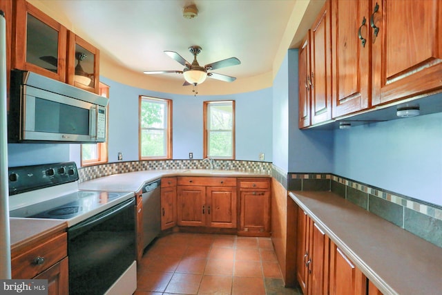 7395 Jonestown Rd, Harrisburg, PA 17112 - kitchen with decorative backsplash, ceiling fan, brown cabinets, and stainless steel appliances