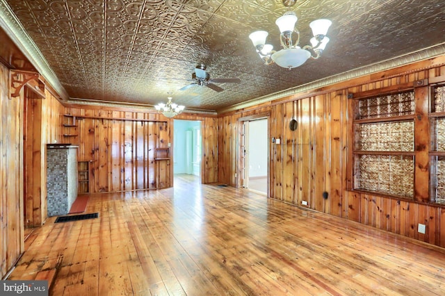 7395 Jonestown Rd, Harrisburg, PA 17112 - unfurnished living room featuring crown molding, wood walls, visible vents, hardwood / wood-style floors, and an ornate ceiling