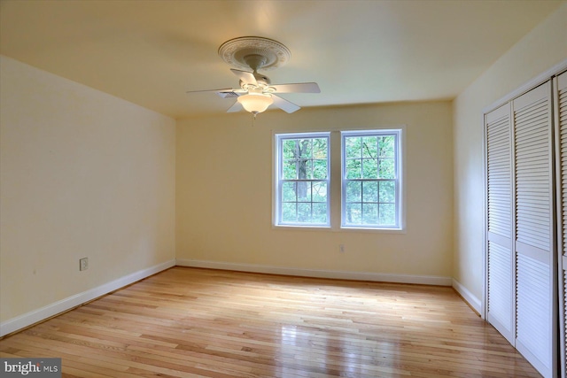 7395 Jonestown Rd, Harrisburg, PA 17112 - unfurnished bedroom with baseboards, a ceiling fan, a closet, and light wood-type flooring