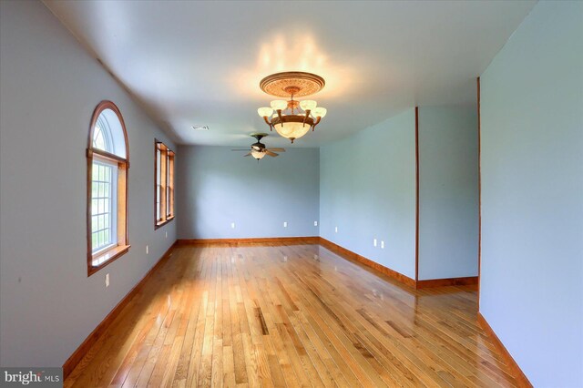 7395 Jonestown Rd, Harrisburg, PA 17112 - unfurnished room featuring light wood-type flooring, baseboards, ceiling fan with notable chandelier, and visible vents