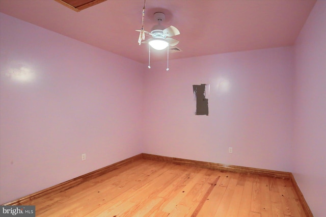 7395 Jonestown Rd, Harrisburg, PA 17112 - unfurnished room with baseboards, electric panel, a ceiling fan, and wood-type flooring