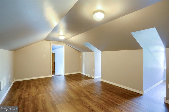 7395 Jonestown Rd, Harrisburg, PA 17112 - additional living space with baseboards, vaulted ceiling, wood finished floors, and visible vents