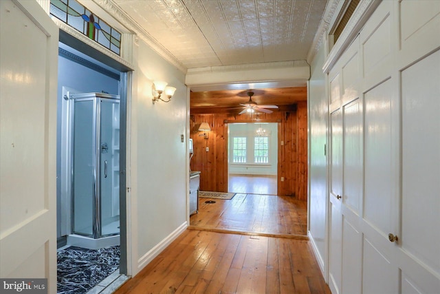 7395 Jonestown Rd, Harrisburg, PA 17112 - hall with crown molding, baseboards, wood walls, and hardwood / wood-style floors