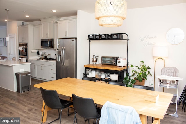 6408 47th St, Riverdale, MD 20737 - kitchen with stainless steel appliances, light countertops, dark wood-style floors, and a toaster