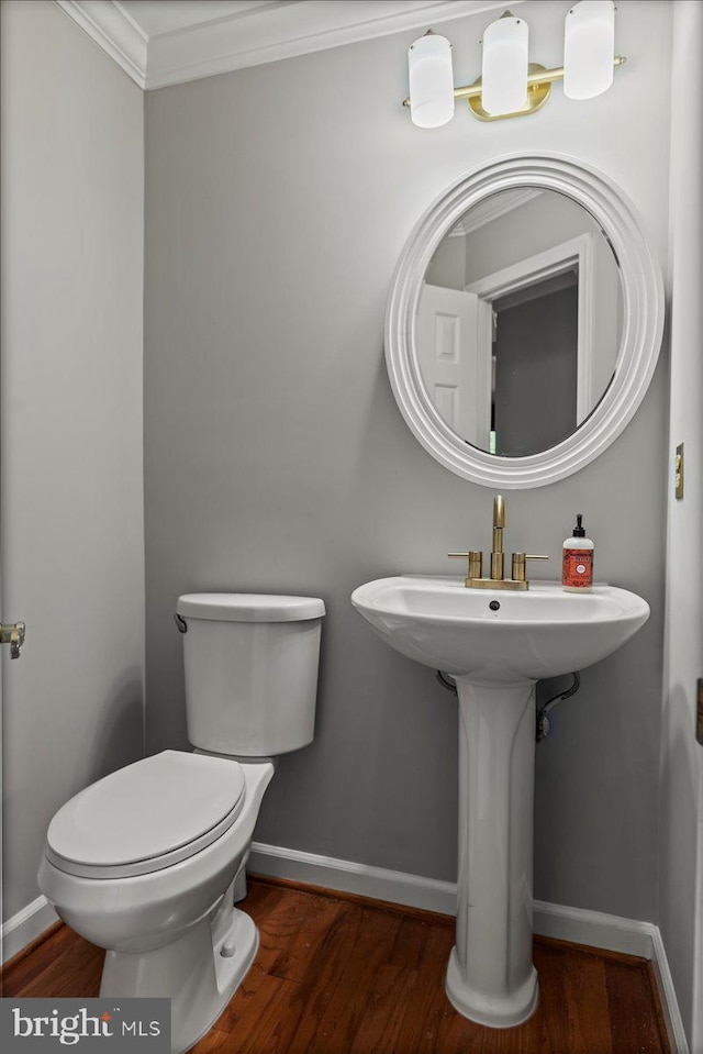 12401 Trotter Ter, Upper Marlboro, MD 20774 - half bathroom featuring toilet, baseboards, wood finished floors, and crown molding