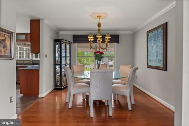 12401 Trotter Ter, Upper Marlboro, MD 20774 - dining area featuring a chandelier, wood finished floors, baseboards, and ornamental molding