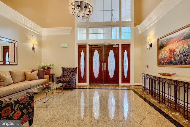 entrance foyer featuring granite finish floor, a high ceiling, and a chandelier