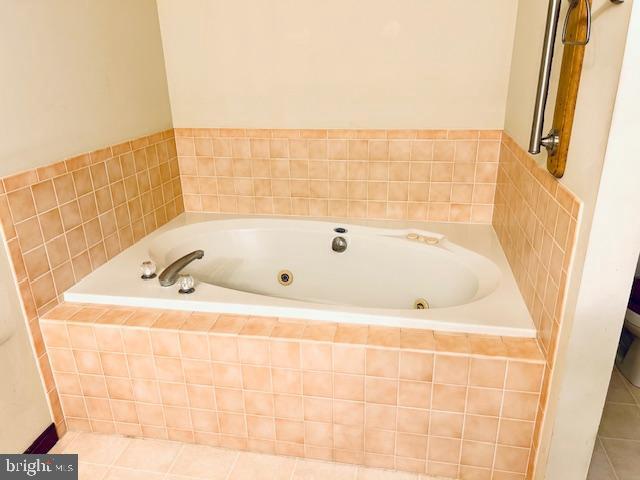 bathroom featuring a jetted tub and tile patterned floors