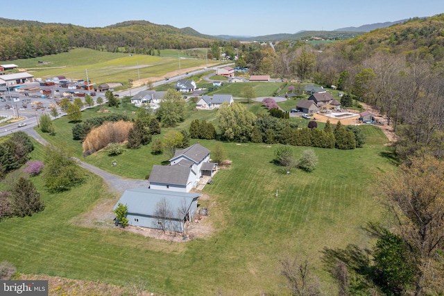 drone / aerial view featuring a mountain view and a forest view