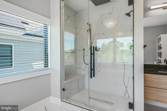 2600 3rd St N, Arlington, VA 22201 - bathroom featuring baseboards, a sink, a wealth of natural light, and a marble finish shower