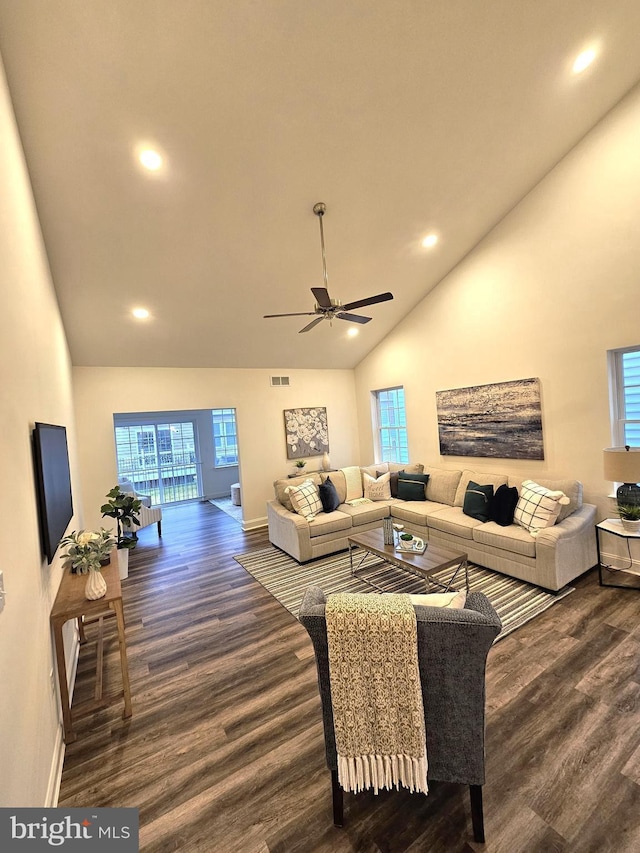 living area featuring high vaulted ceiling, wood finished floors, healthy amount of natural light, baseboards, and recessed lighting