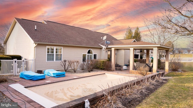 1222 Brian Ln, Hanover, PA 17331 - back of house at dusk featuring a patio, fence, and a shingled roof