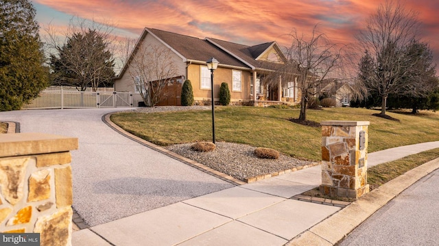 1222 Brian Ln, Hanover, PA 17331 - property exterior at dusk featuring a gate, driveway, an attached garage, and stucco siding