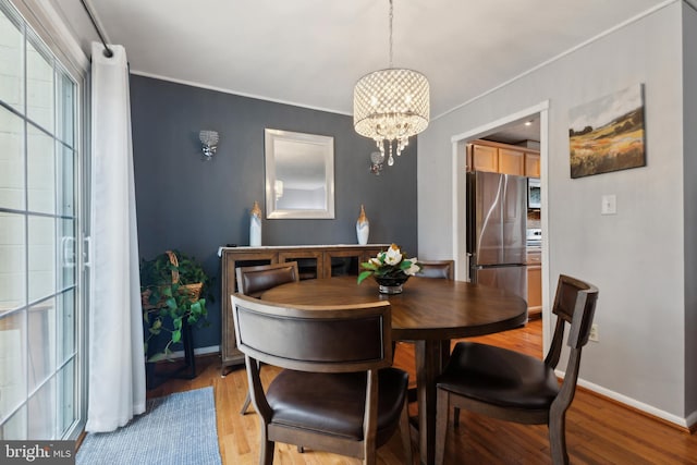 12328 Woodlawn Ct, Woodbridge, VA 22192 - dining room featuring a chandelier, light wood-type flooring, crown molding, and baseboards