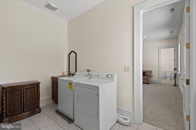 14815 Dover Rd, Reisterstown, MD 21136 - clothes washing area featuring light tile patterned floors, cabinet space, washing machine and clothes dryer, a sink, and visible vents
