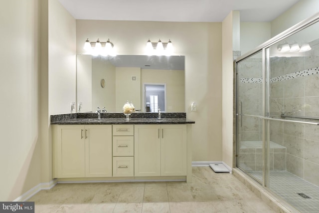 20620 Hope Spring Ter Unit 206, Ashburn, VA 20147 - bathroom featuring double vanity, a shower stall, and baseboards