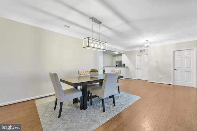 20620 Hope Spring Ter Unit 206, Ashburn, VA 20147 - dining area featuring wood finished floors, ornamental molding, and baseboards