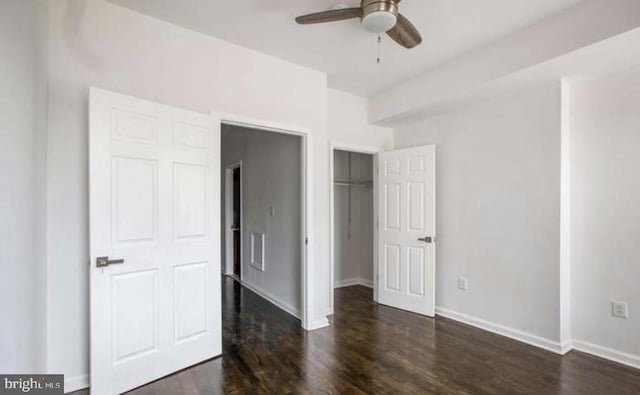 unfurnished bedroom with baseboards, dark wood finished floors, and ceiling fan