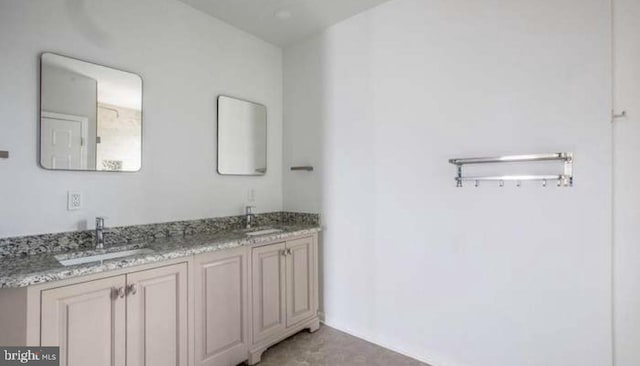 full bath featuring a sink and double vanity