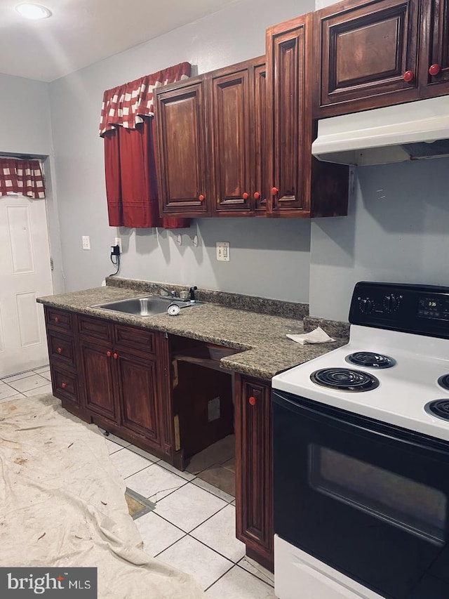kitchen featuring a sink, dark countertops, under cabinet range hood, electric stove, and light tile patterned floors