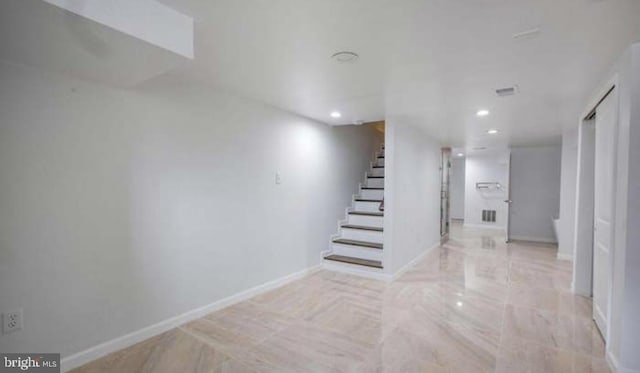 interior space featuring recessed lighting, baseboards, and stairs