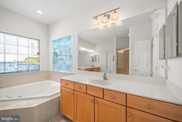 bathroom with a garden tub, tile patterned flooring, a stall shower, and vanity