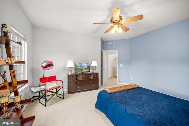 bedroom with baseboards, light carpet, a ceiling fan, and visible vents