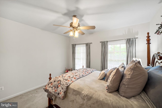 bedroom with baseboards, ceiling fan, and light colored carpet