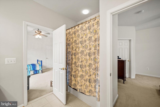 bathroom with baseboards, ceiling fan, a shower with shower curtain, and tile patterned flooring